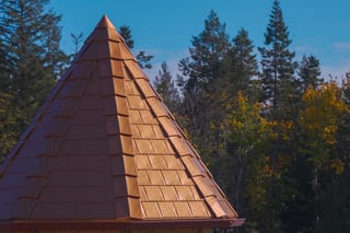 Copper Penny Interlock Slate aluminum roof on a brown roofed home with copper penny metal shingles in a, Ladysmith, British Columbia