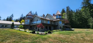 Before: a worn out wood shake roof on the home, Ladysmith, British Columbia, ahead of a Copper Penny Interlock Slate aluminum roof