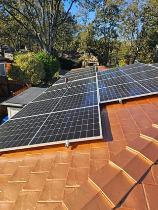 Copper Penny Interlock Slate aluminum roof on a brown single-storey home with a copper penny metal roof, Victoria, British Columbia
