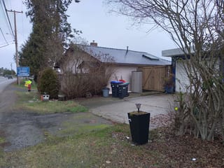 Black Interlock Slate aluminum roof on a white single-family home with a metal roof in a rural, Qualicum, British Columbia
