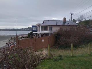 Black Interlock Slate aluminum roof being installed on a modern home with a metal roof under construction by the, Qualicum, British Columbia