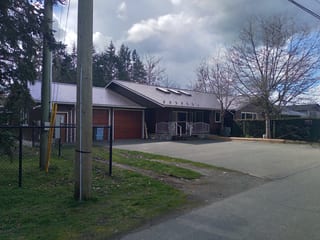 Tudor Brown Interlock Slate aluminum roof on a brown home with a metal roof in a rural setting, Duncan, British Columbia