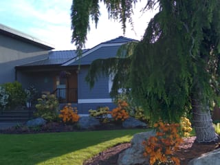 Deep Charcoal Interlock Slate aluminum roof on a Deep Charcoal metal roof on a modern home in a lush, Victoria, British Columbia
