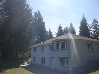 Before: a worn out asphalt shingle roof on the home, Courtenay, British Columbia, ahead of a Deep Charcoal Interlock Slate aluminum roof