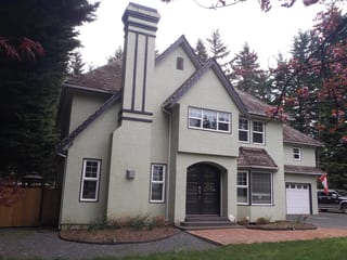 Before: a worn out wood shake roof on the home, Bowser, British Columbia, ahead of a Deep Charcoal Interlock Slate aluminum roof