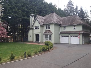 Before: a worn out wood shake roof on the home, Bowser, British Columbia, ahead of a Deep Charcoal Interlock Slate aluminum roof