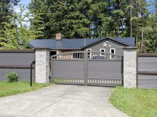 Black Interlock Slate aluminum roof on a grey ranch-style home with a metal roof in a coastal, Comox, British Columbia