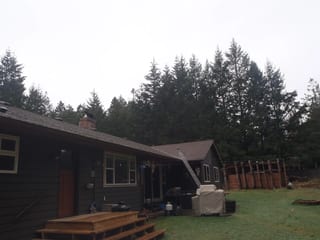 Before: a leaking asphalt shingle roof on the home, Comox, British Columbia, ahead of a Black Interlock Slate aluminum roof