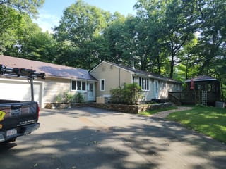 Colonial Brown Interlock Shingle aluminum roof on a colonial style single-family home with a metal roof among, Burlington, Connecticut
