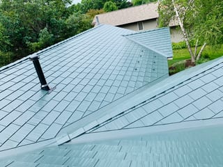 Hunter Green Interlock Shingle aluminum roof on a single-storey home with a hunter green metal roof in a, Winnebago, Illinois