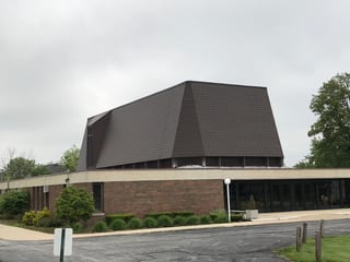 White Interlock IB Membrane aluminum roof being installed on a brick house with a metal roof in a suburban neighbourhood, Chicago Heights, Illinois