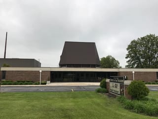 White Interlock IB Membrane aluminum roof on a red brick church with a brown roof in a suburban setting, Chicago Heights, Illinois
