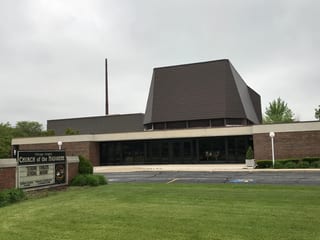 White Interlock IB Membrane aluminum roof on a brown brick church with a metal roof in a suburban, Chicago Heights, Illinois