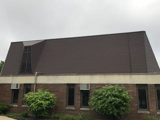 White Interlock IB Membrane aluminum roof on a red brick home with dormers in an urban area, Chicago Heights, Illinois