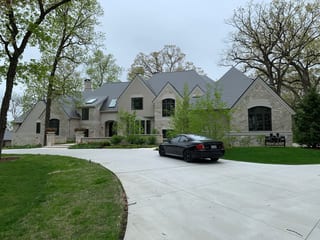 Musket Grey Interlock Slate aluminum roof being installed on the home, replacing an asphalt shingle roof being torn off, Long Grove, Illinois