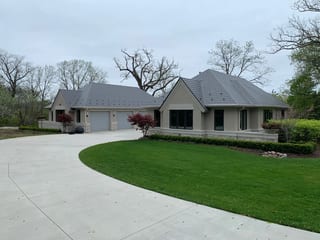Musket Grey Interlock Slate aluminum roof on a beige single-storey home with a metal roof in a suburban, Long Grove, Illinois