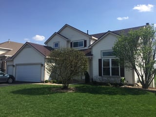 Colonial Brown Interlock Slate aluminum roof on a Colonial home with two storeys and dormers in a lush, Carol Stream, Illinois