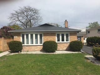 Black Interlock Slate aluminum roof on a beige ranch style home with a black metal roof in a, Skokie, Illinois