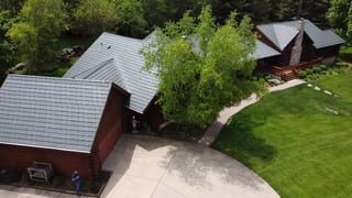 Hunter Green Interlock Shake aluminum roof on a brown house with a hunter green metal roof in a rural, Harvard, Illinois