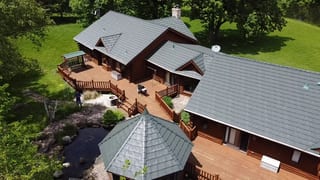 Hunter Green Interlock Shake aluminum roof on a green ranch house with a hunter green metal roof in rural, Harvard, Illinois