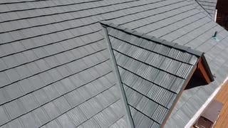 Hunter Green Interlock Shake aluminum roof on a brown two-storey home with dormers on a rural acreage, Harvard, Illinois