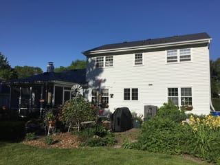 Black Interlock Slate aluminum roof on a white two-storey colonial home with dormers in a suburban, Batavia, Illinois