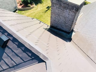Tudor Brown Interlock Slate aluminum roof on a Tudor brown metal roof on a colonial style house in a, Roselle, Illinois