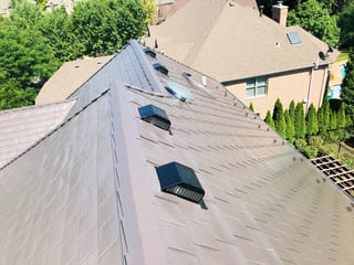 Tudor Brown Interlock Slate aluminum roof on a Tudor brown metal roof on a colonial home in a forested, Roselle, Illinois