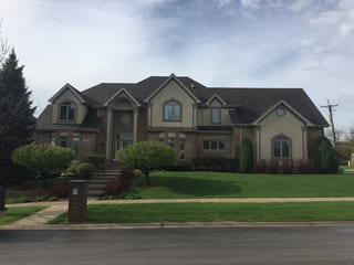 Tudor Brown Interlock Slate aluminum roof on a Tudor Brown colonial style home on a green suburban lawn, Roselle, Illinois