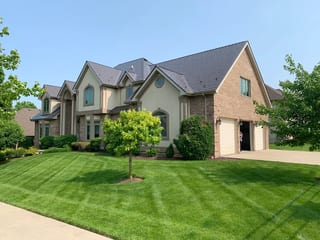 Tudor Brown Interlock Slate aluminum roof on a Tudor style single-family home with lush greenery, Roselle, Illinois