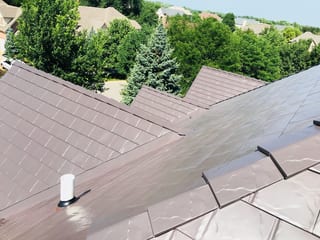 Tudor Brown Interlock Slate aluminum roof on a two-storey Tudor home with dormers in a suburban, Roselle, Illinois