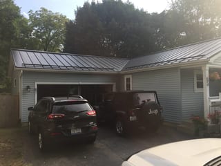 Black Interlock Standing Seam aluminum roof on a two-storey home with a metal roof in a rural setting, Woodstock, Illinois