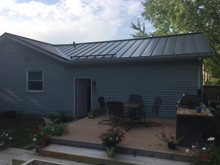 Black Interlock Standing Seam aluminum roof on a two-storey home with metal roof under construction in a, Woodstock, Illinois