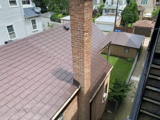 Colonial Brown Interlock Slate aluminum roof on a Colonial style house with a brown roof in an urban, Chicago, Illinois