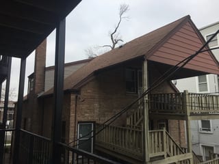 Before: a leaking asphalt shingle roof on the home, Chicago, Illinois, ahead of a Colonial Brown Interlock Slate aluminum roof