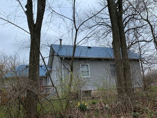 Royal Blue Interlock Slate aluminum roof on a metal roof under construction on a ranch home in a rural, Woodstock, Illinois