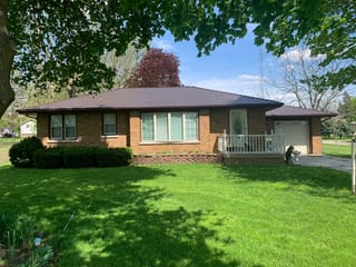 Colonial Brown Interlock Cedar Shingle aluminum roof on a brown Colonial home in a lush green landscape, Wenona, Illinois