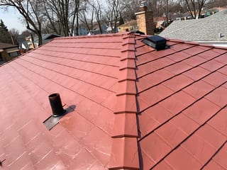 Tile Red Interlock Slate aluminum roof on a red two-storey home with dormers in a suburban, Calumet Park, Illinois