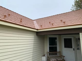 Copper Penny Interlock Cedar Shingle aluminum roof on a white single-family home with a metal roof in a suburban, Bolingbrook, Illinois
