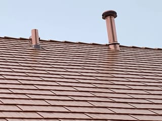 Copper Penny Interlock Cedar Shingle aluminum roof on a brown single-family home with a copper penny roof in a, Bolingbrook, Illinois