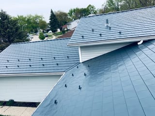 Deep Charcoal Interlock Slate aluminum roof on a Deep Charcoal Interlock Slate metal roof on a white, Elgin, Illinois