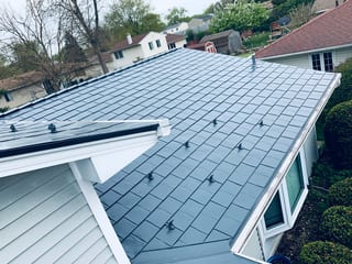 Deep Charcoal Interlock Slate aluminum roof on a single-family home with a deep charcoal metal roof in, Elgin, Illinois
