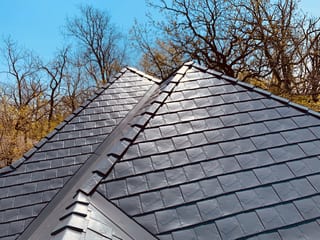 Deep Charcoal Interlock Slate aluminum roof on a gray house with a metal roof in a forest near a lake, Crystal Lake, Illinois