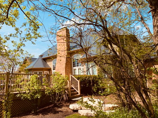 Deep Charcoal Interlock Slate aluminum roof on a single-family home in a suburban lakeside setting, Crystal Lake, Illinois