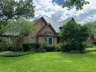 Deep Charcoal Interlock Slate aluminum roof on a red brick home with a metal roof and two gables in a, Crystal Lake, Illinois