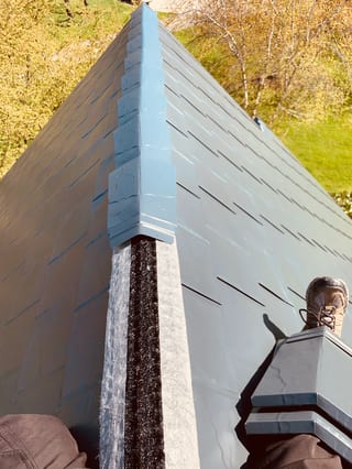 Deep Charcoal Interlock Slate aluminum roof being installed on a single-family home with a metal roof and a green lawn, Crystal Lake, Illinois
