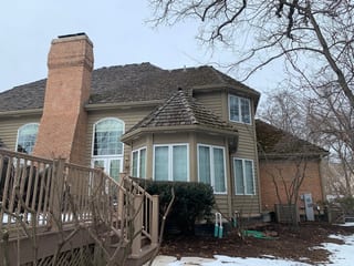 Before: a worn out wood shake roof on the home, Crystal Lake, Illinois, ahead of a Deep Charcoal Interlock Slate aluminum roof