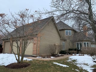 Before: a worn out wood shake roof on the home, Crystal Lake, Illinois, ahead of a Deep Charcoal Interlock Slate aluminum roof