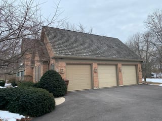 Before: a worn out wood shake roof on the home, Crystal Lake, Illinois, ahead of a Deep Charcoal Interlock Slate aluminum roof