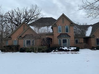 Before: a worn out wood shake roof on the home, Crystal Lake, Illinois, ahead of a Deep Charcoal Interlock Slate aluminum roof